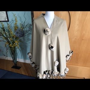 A designer wool wrap with the real fur balls.